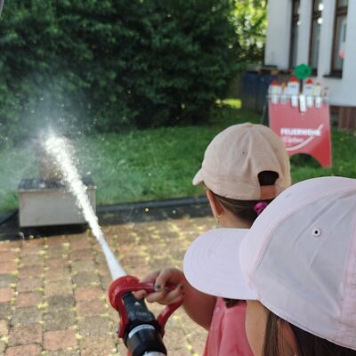 Bild vergr&ouml;&szlig;ern: Kinder spritzen mit Feuerwehr-Schlauch